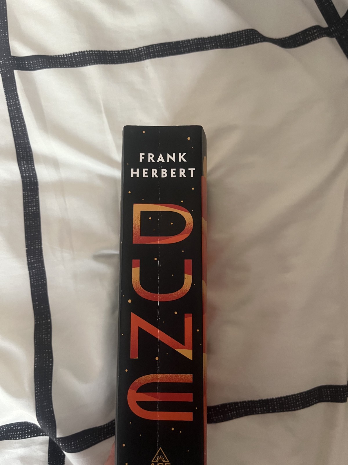 Dune by Frank Herbert. Paperback, like new. Broken in spine.