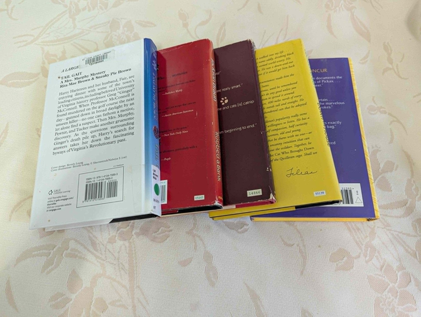 4 “The Cat Who” books by Lilian Jackson Braun, 1 by Rita Mae Brown (“Tail Gait”)