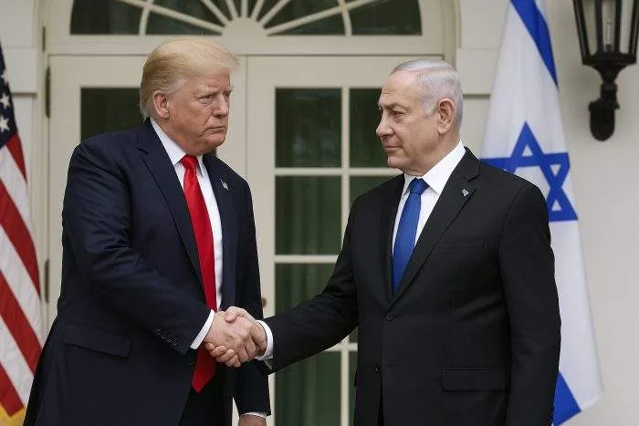 Former U.S. President Donald Trump and Israeli Prime Minister Benjamin Netanyahu shake hands outside the White House, with American and Israeli flags in the background.