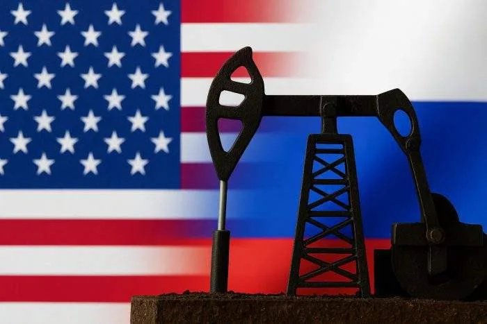 Oil pump silhouette set against merged U.S. and Russian flags, symbolizing geopolitical tensions and energy sanctions.