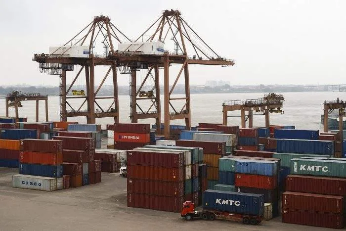 Cargo containers and cranes at Chattogram Port, Bangladesh, during export operations.