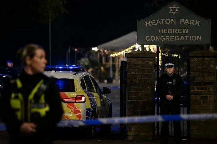Police secure the scene outside Heaton Park Hebrew Congregation in Manchester after a car and knife attack on Yom Kippur.