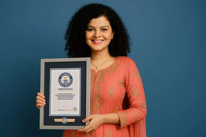 Indian playback singer Palak Muchhal smiles while holding her Guinness World Records certificate.