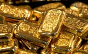 Gold bullion bars and precious metals trading visuals reflecting record-high global gold prices.
