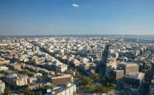 Washington, DC skyline with economic visuals symbolizing strong US economic growth amid rising inflation.