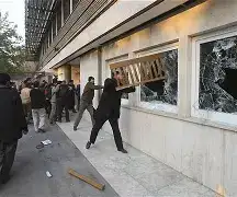 The British Embassy gates in Tehran, Iran, closed with a "Consular Services Suspended" notice visible.