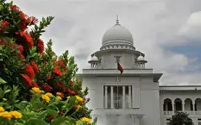 A close-up of a legal document with a signature line, resting on a wooden desk with the Supreme Court of Bangladesh in the background.
