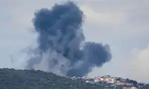 Thick black smoke rising from the southern suburbs of Beirut, with Israeli fighter jets visible in the distance over the Mediterranean.