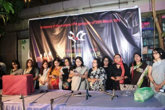 People gather in Dhanmondi to light candles in remembrance of the March 25, 1971 genocide victims.