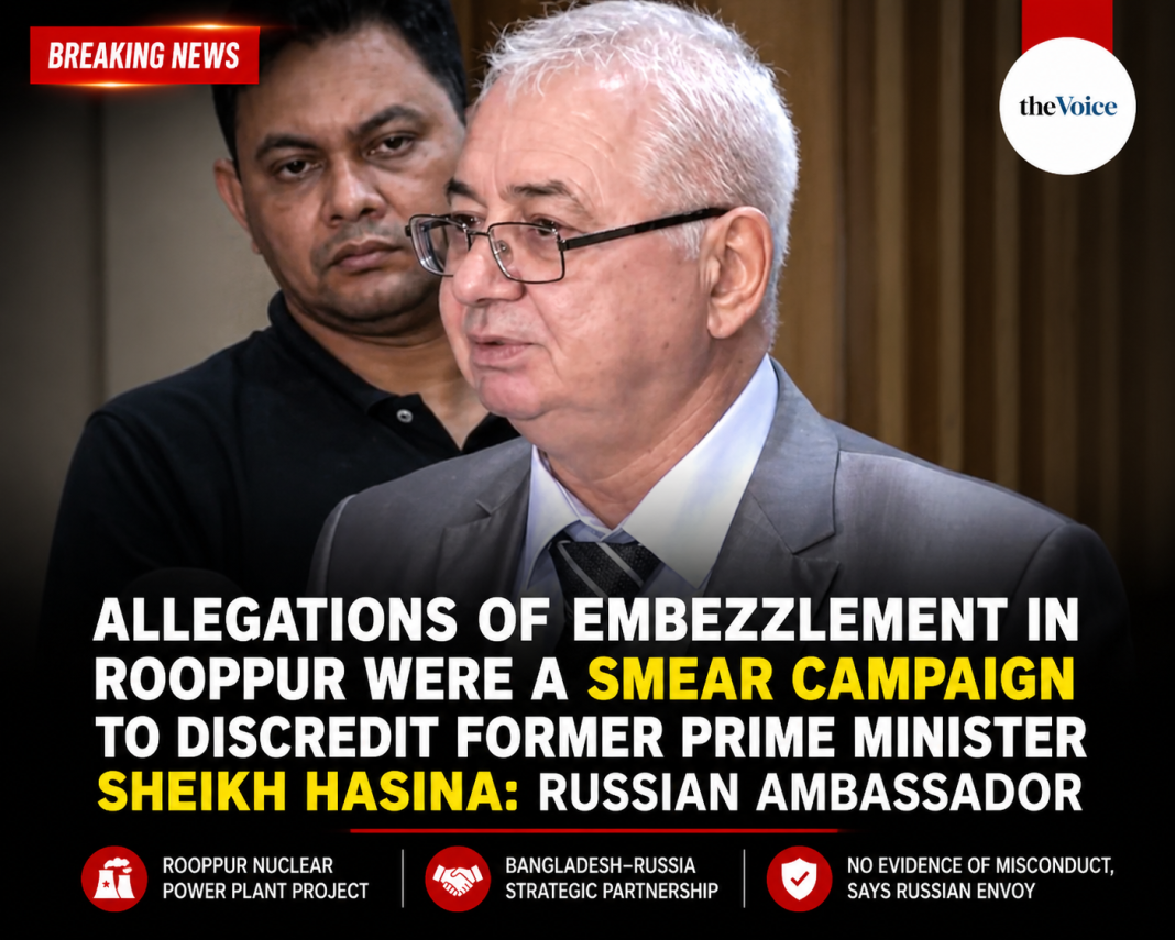 A Russian diplomat speaks at a press briefing while another man stands behind him, with a bold news headline stating that Rooppur embezzlement allegations were a smear campaign against Sheikh Hasina.
