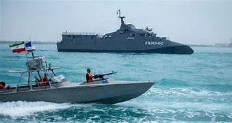 High-speed Iranian attack boats maneuver near a US Navy destroyer in the Strait of Hormuz during a military standoff in May 2026.