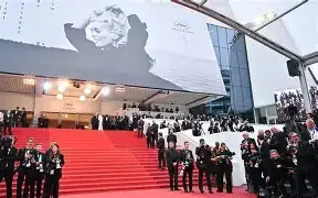 Festival Jury President Park Chan-wook standing alongside jury members, including Demi Moore, on the red carpet steps of the Palais des Festivals.
