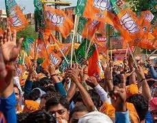 Prime Minister Narendra Modi waving to a large, cheering crowd during a celebratory event following the West Bengal election results.