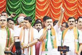 BJP workers at the Salt Lake headquarters in Kolkata serving jhalmuri and traditional fish curry to guests amidst a backdrop of Rabindra Sangeet and campaign celebrations.