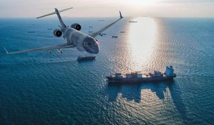 Horizontal view of an oil tanker adrift in the Gulf of Oman with smoke visible near the stern.