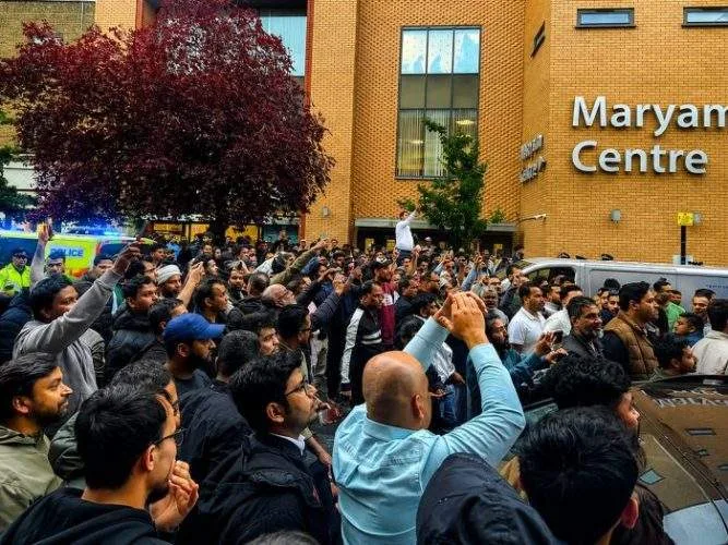 Supporters and activists gather outside the Maryam Centre in East London during a protest linked to an event attended by NCP leader Hasnat Abdullah, as police monitor the situation.