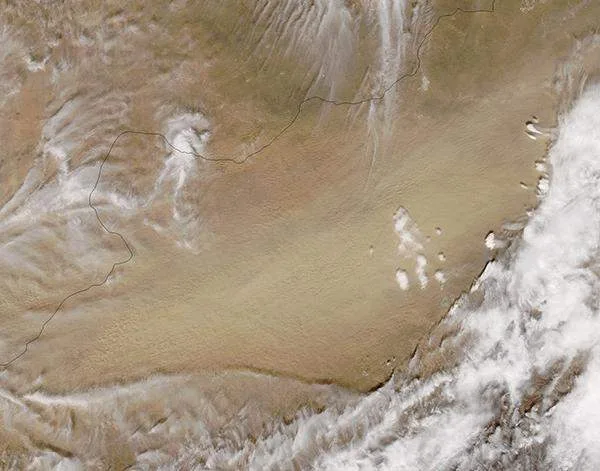 A high-tech digital meteorological interface displaying an active storm tracking map, with data overlay showing air pollution levels over northwestern China.