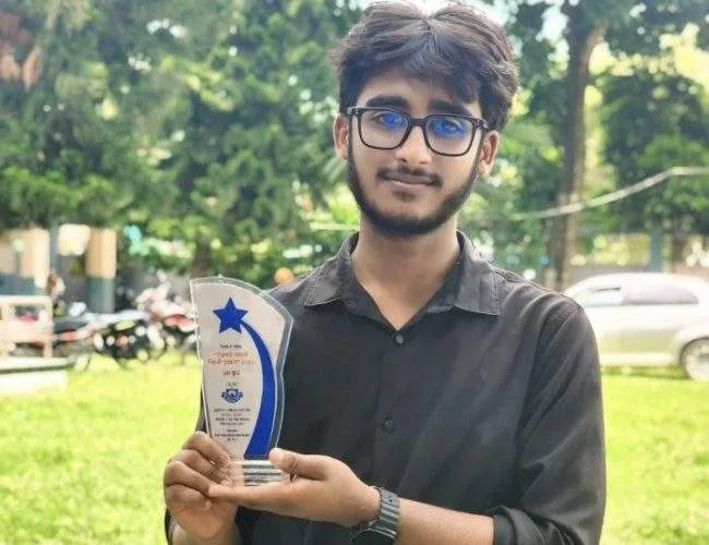 Horizontal view of Huraira Ahmed Naim receiving the first prize at the Dhunat Upazila level innovative competition.