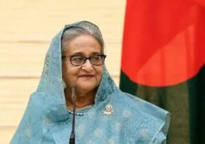A text document detailing a news report from New Delhi about former Bangladeshi Prime Minister Sheikh Hasina's plans to return to Bangladesh in December to voluntarily surrender before a court.