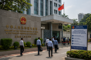Horizontal shot showing the Chinese Embassy building in Dhaka with visitors near the entrance.