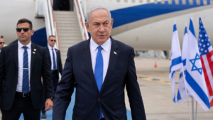 Horizontal shot of Israeli Prime Minister Benjamin Netanyahu walking near an aircraft as he departs for Washington.