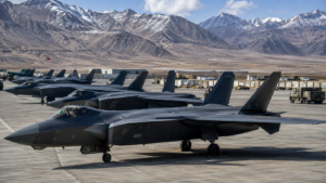 Horizontal shot showing Chinese fifth-generation J-20 stealth fighter jets parked on a high-altitude military tarmac.