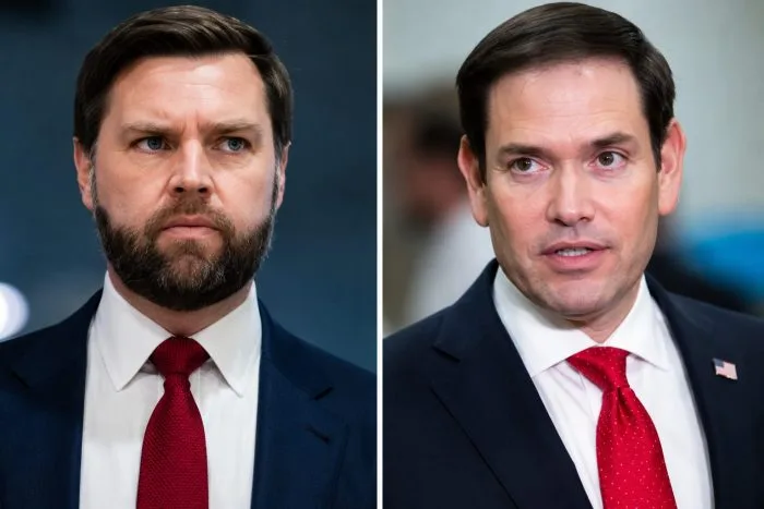 A high-resolution horizontal photograph of Vice President JD Vance and Secretary of State Marco Rubio seated at a glossy conference table inside the White House West Wing. They are reviewing foreign policy dossiers together under soft indoor architectural lighting, capturing a rare moment of direct diplomatic collaboration.