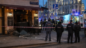 Emergency responders and Russian security personnel surrounding the blast site outside a Moscow restaurant